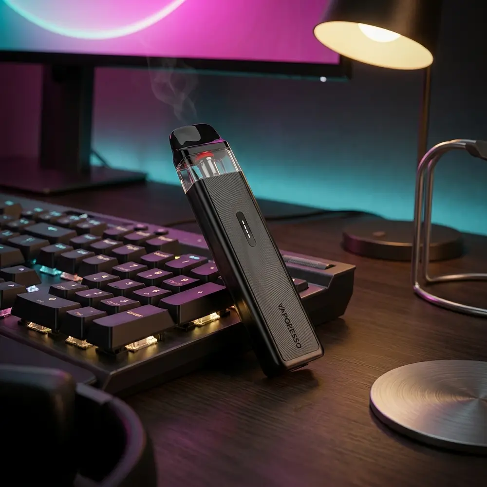 Vaporesso XROS 5 Mini sobre mesa gamer com luzes RGB, teclado mecanico desfocado e atmosfera noturna urbana - Vapor Gringo