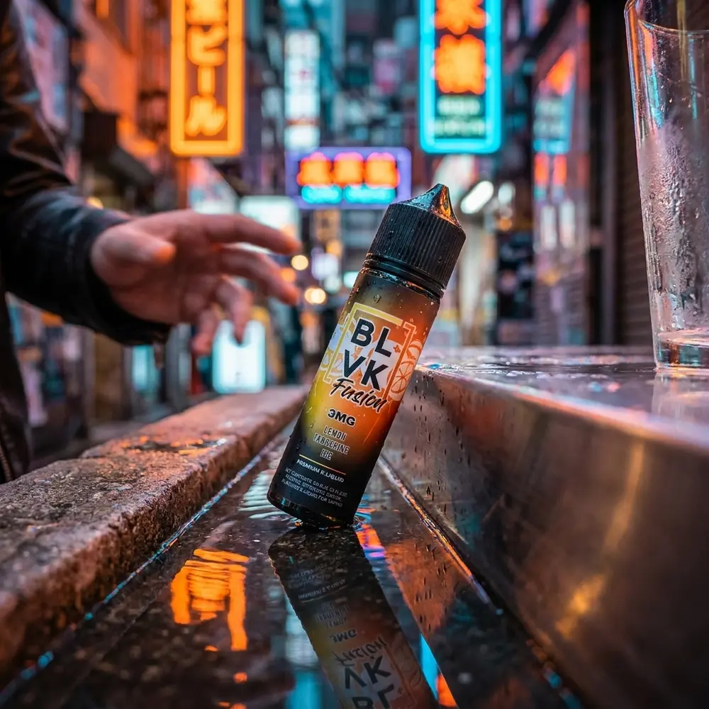 Garrafa Blvk Unicorn Lemon Tangerine Ice apoiada em meio urbano neon, com superfice molhada e luzes difusas - Vapor Gringo