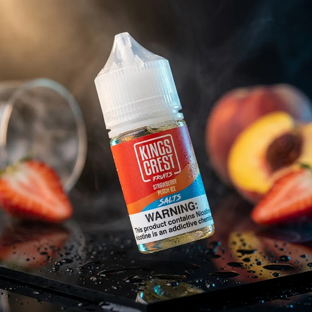 Garrafa de líquido Kings Crest Salt Strawberry Peach Ice sobre base preta brilhante com condensação e luz dramática. - Vapor Gringo