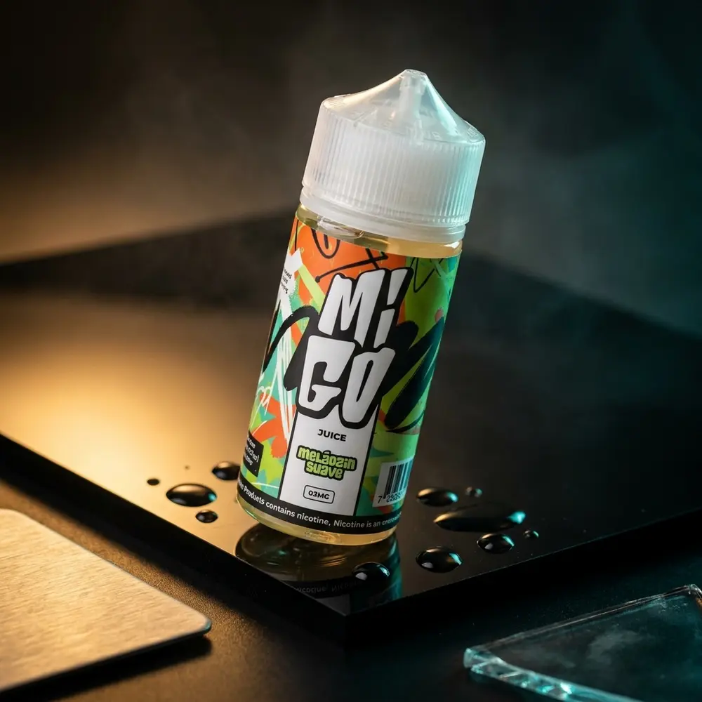 Frasco Liquido Migo Melozin Suave 100ml sobre base acrilica preta, iluminação teal e âmbar, rótulo legível - Vapor Gringo
