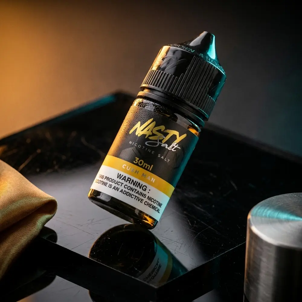 Garrafa Liquido Nasty Juice Salt Cush Man manga em close sobre acrilico preto com luzes quentes e azuis. - Vapor Gringo