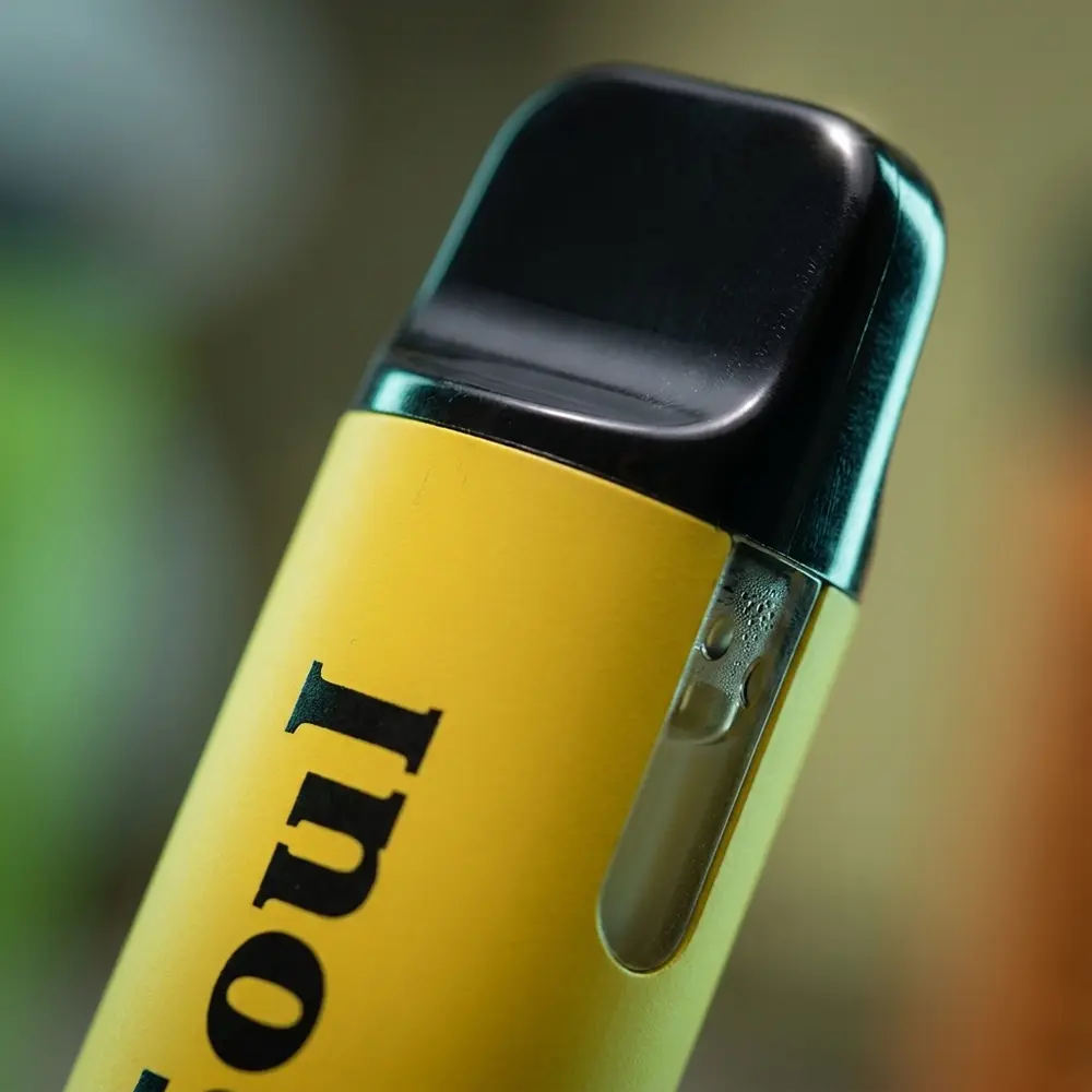Close-up do bocal e rotulo do Pod Vapesoul Banana Milk Mint com gotas e reflexos precisos - Vapor Gringo