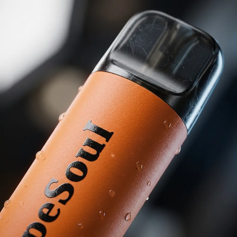 Detalhe macro do pod Vapesoul Peach Mango mostrando bocal, rótulo e goticulas de condensacao na superficie - Vapor Gringo