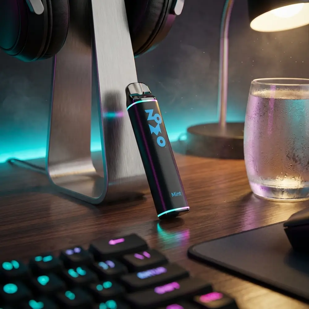 Pod Zomo Party Mint 800 puffs sobre mesa gamer com reflexos RGB, teclado mecanico e copo condensado - Vapor Gringo