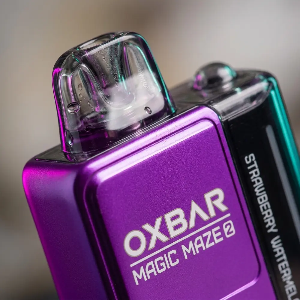 Detalhe macro do Pod Descartavel Oxbar Magic Maze 2.0 mostrando logo, bocal e condensacao com reflexos metalicos - Vapor Gringo