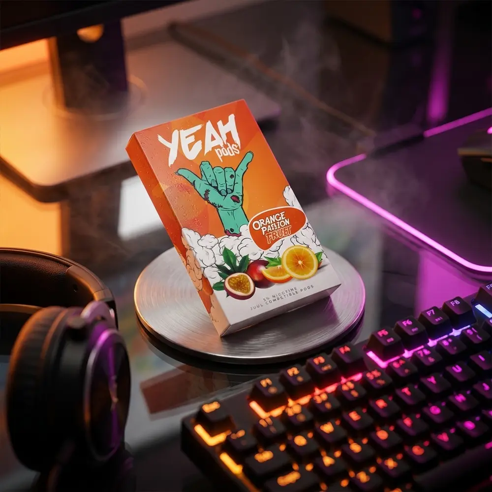 Refil Pod Yeah Orange Passion Fruit sobre mesa gamer RGB com teclado desfocado e luzes neon laranja - Vapor Gringo
