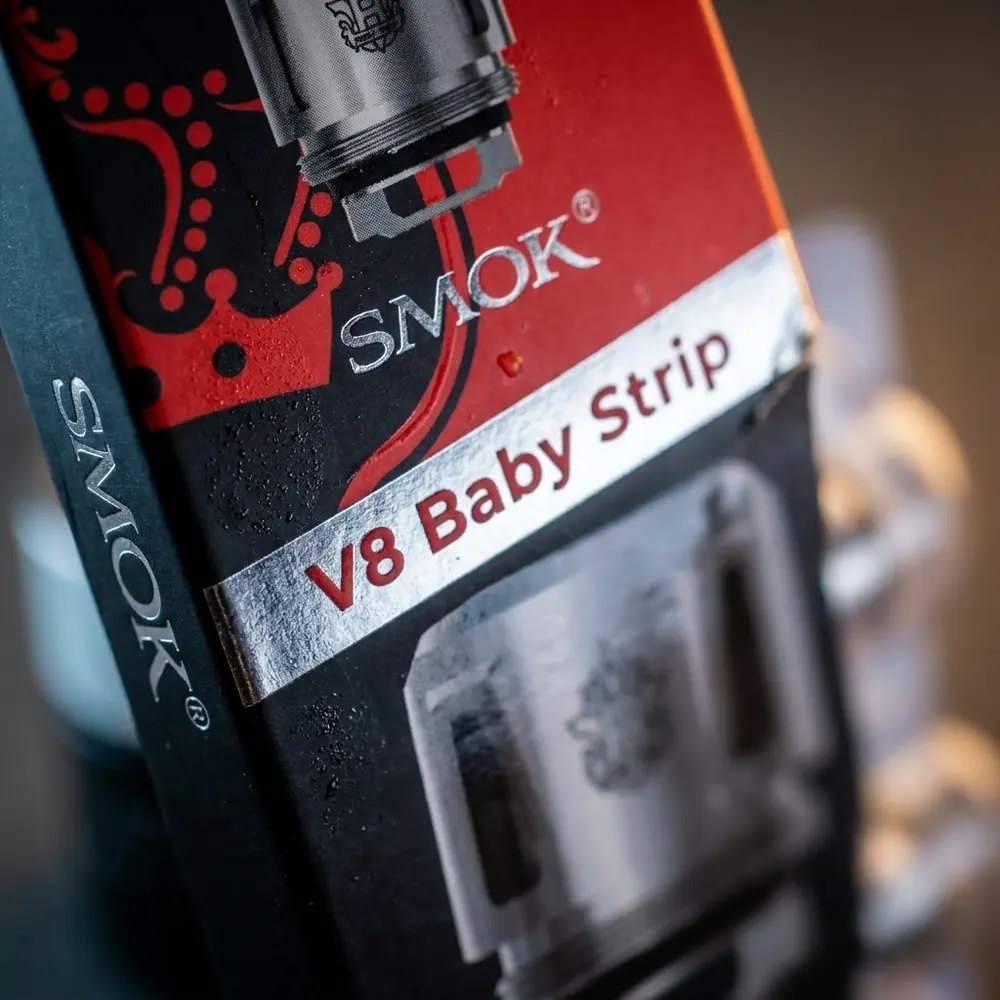 Close-up da embalagem Strip Smok mostrando logo, tipografia e textura com gotas de condensação - Vapor Gringo