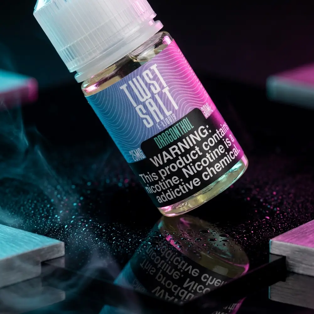 Frasco Twst Dragonthol 30ml inclinado sobre base acrilica molhada com reflexos neon roxos e azuis e gotas de condensacao - Vapor Gringo