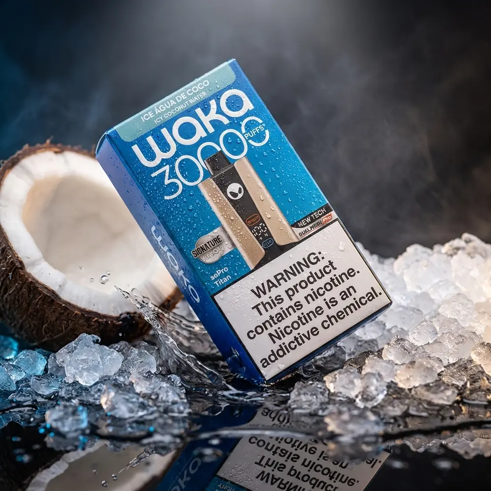 Pod descartavel Waka soPRO Titan Icy Coconut Water inclinado sobre acrilico preto com gelo e metade de coco, gotas visiveis - Vapor Gringo